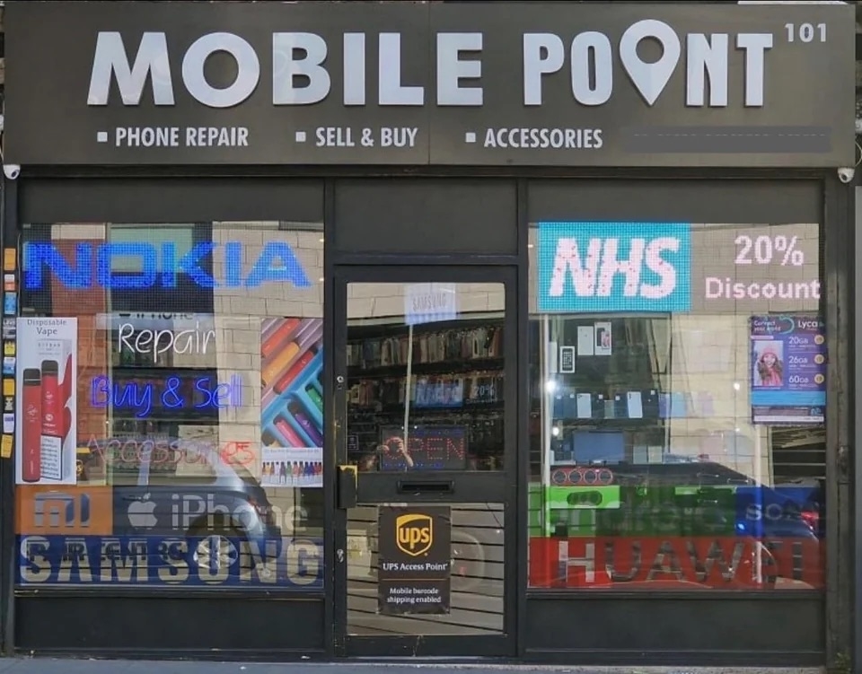 a store front with the name mobile point; a point icon replaces the i in point
