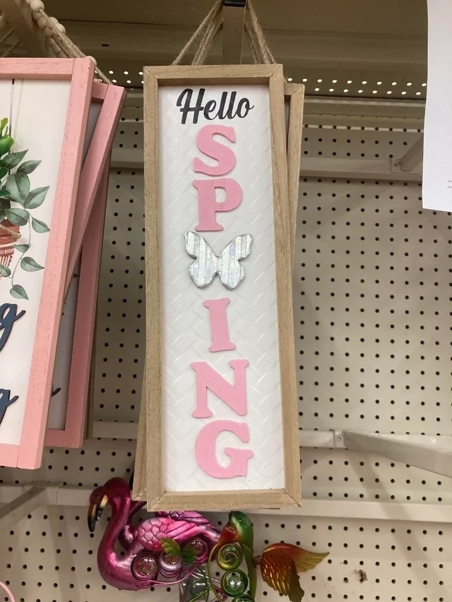 a sign that reads &quot;hello spring&quot; but the r in spring is replaced with a butterfly