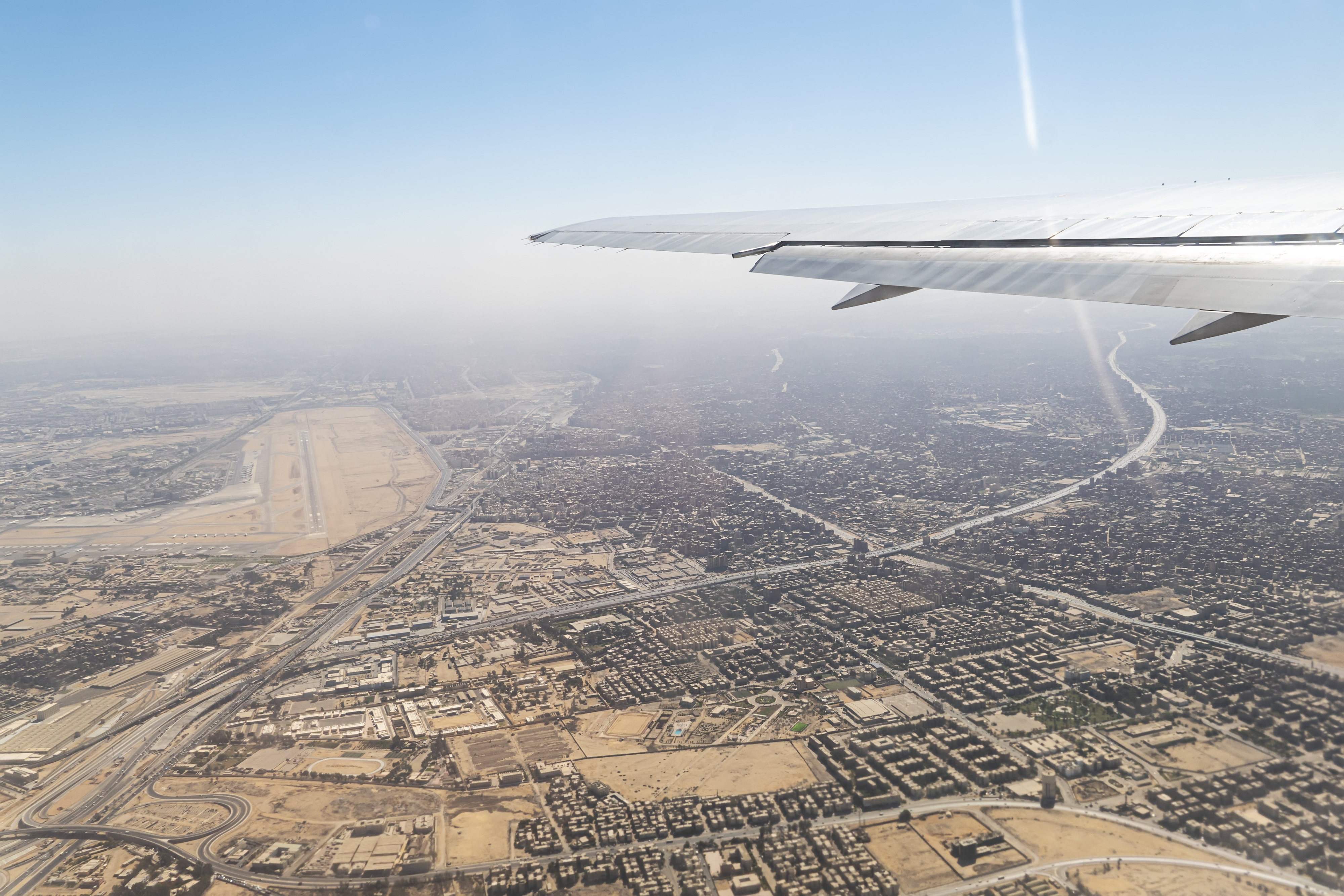 wing of a passenger plane against the background of Cairo
