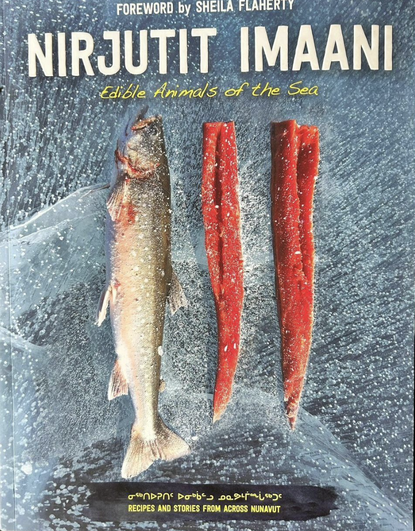 A book cover displays a fish and then fish meat. The title is &quot;Nirjutit Imaani: Edible Animals of the Sea.&quot;