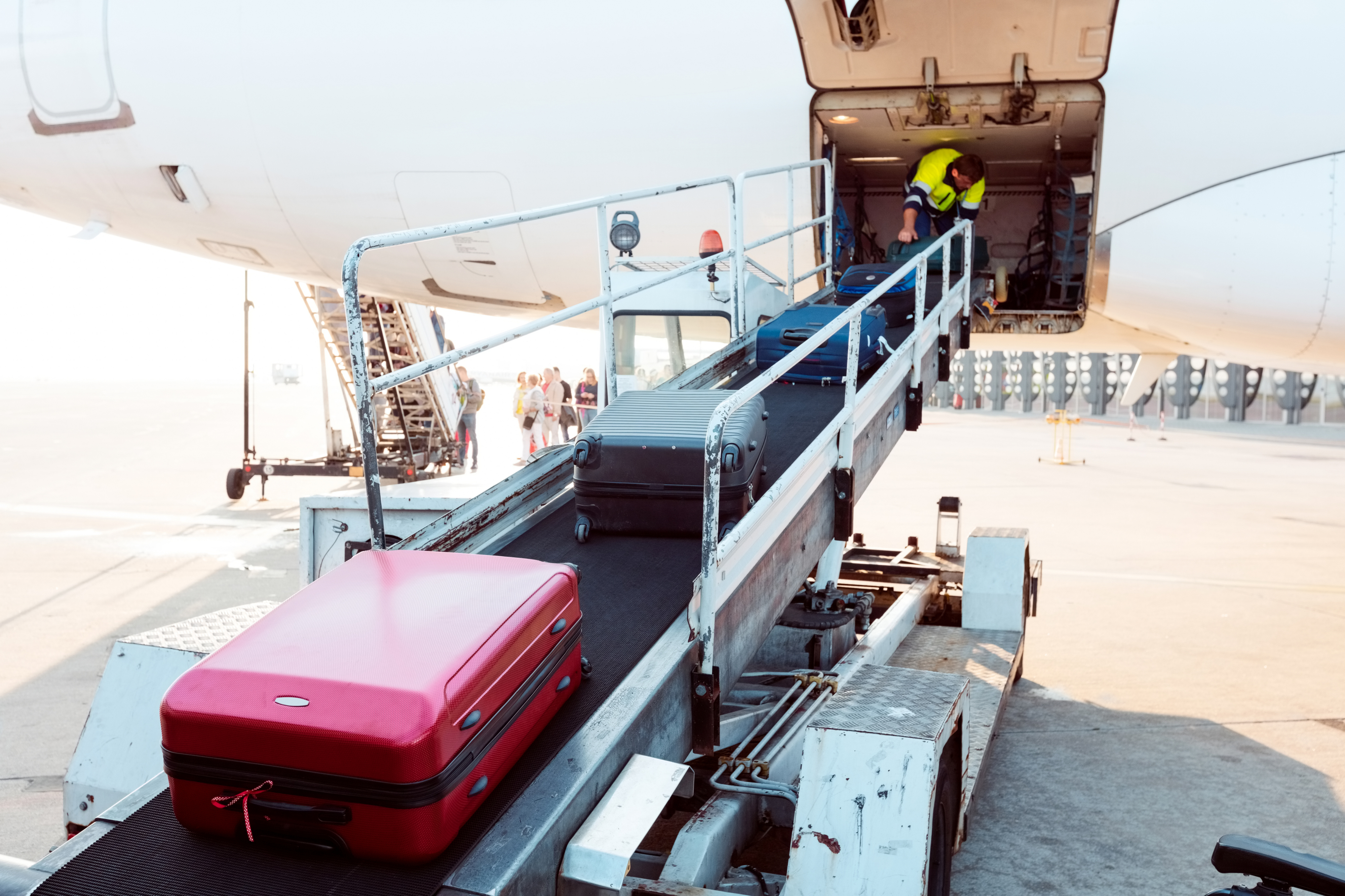 luggage being unloaded from a plane