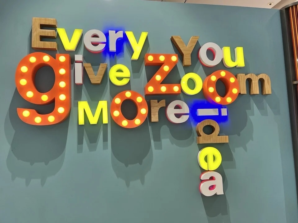 block letters on a wall that seemingly read &quot;every you give zoom more idea&quot;