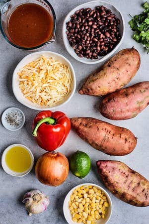 ingredients for enchilada stuffed sweet potatoes laid out on a table