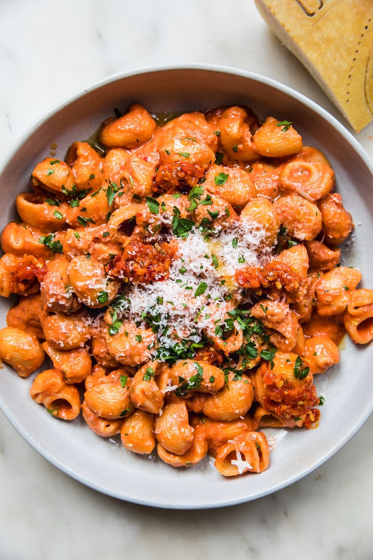 calabrian chilii pasta on a plate topped with parmesan and herbs
