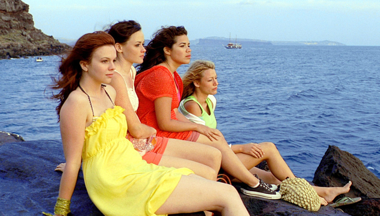 The friends sitting on rocks by the sea in a scene from &quot;The Sisterhood of the Traveling Pants&quot;
