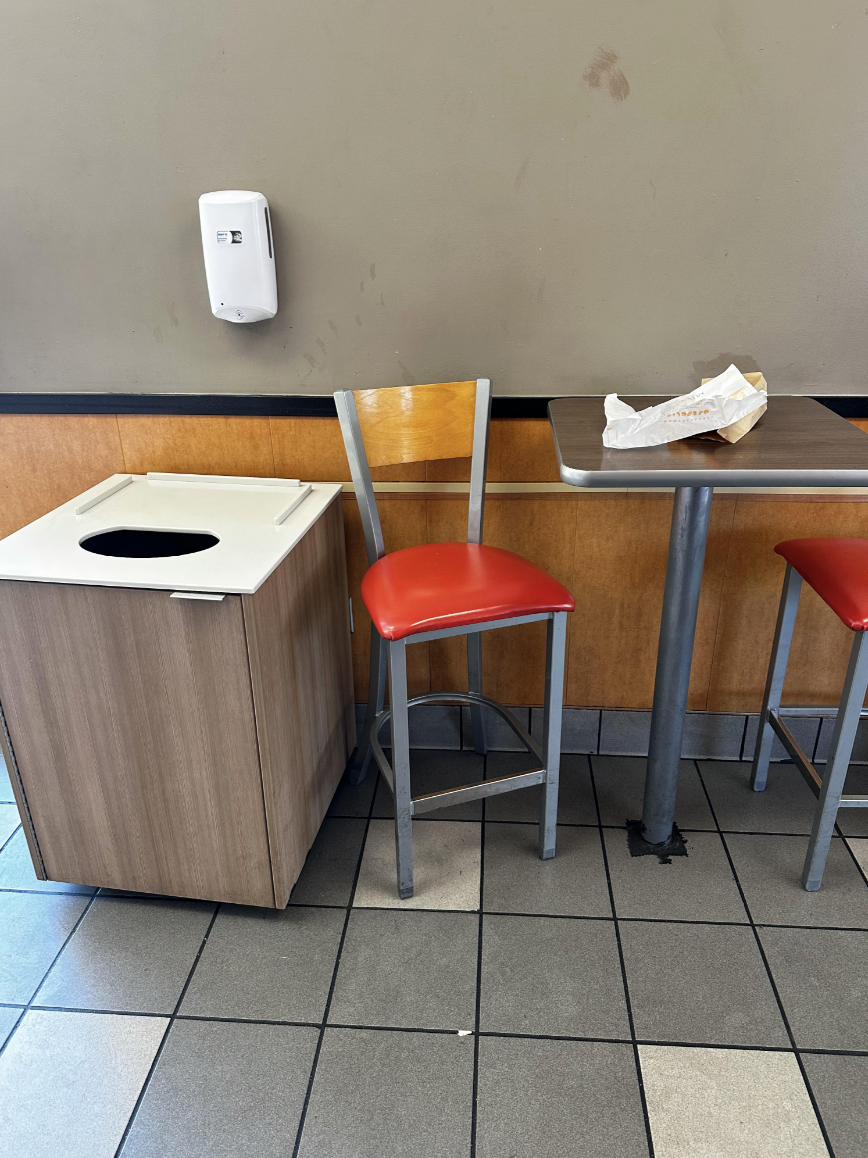 Trash on a table near a trash can