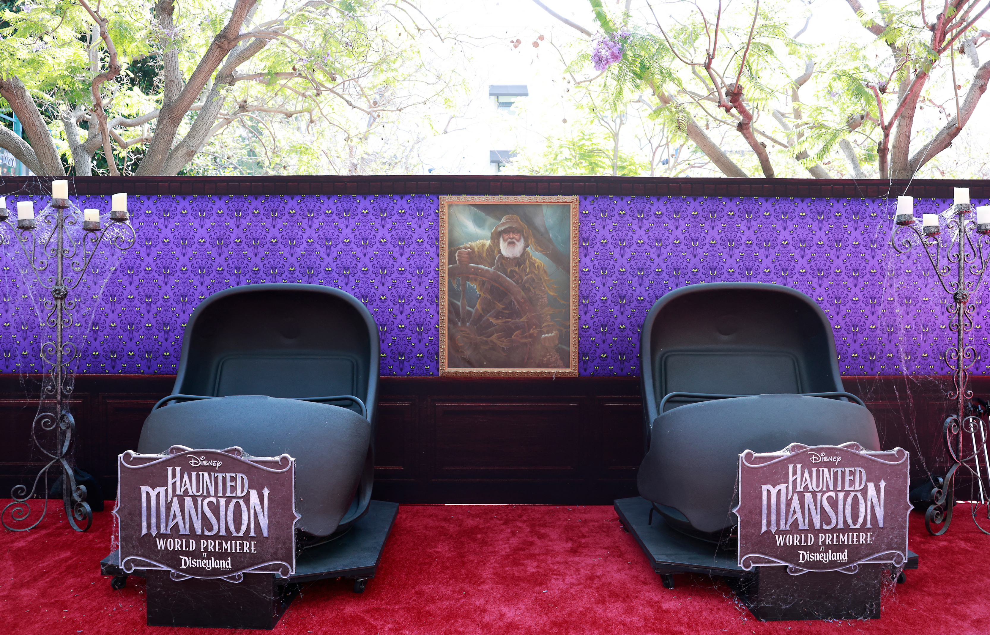 the red carpet has two large empty roller coaster chairs