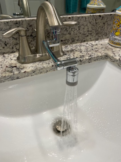 A faucet extender in a bathroom sink