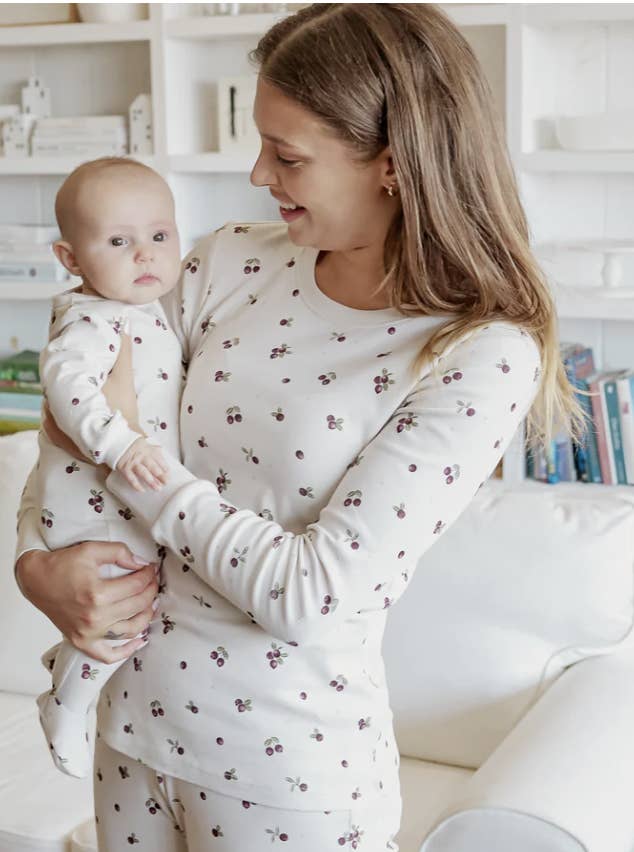 A baby and a mom in matching pajamas
