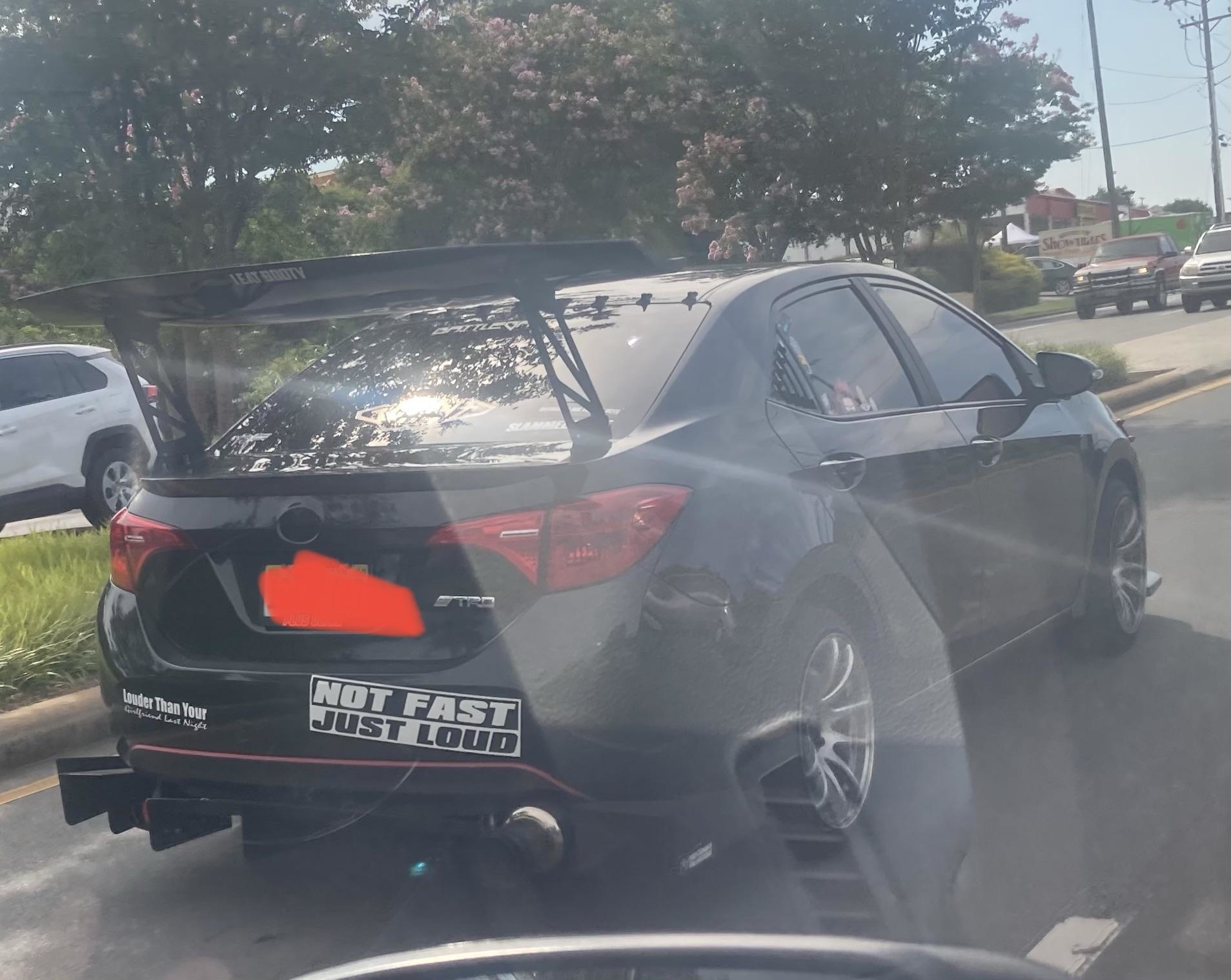 A Toyota car with a bumper sticker that says &quot;Not fast just loud&quot;