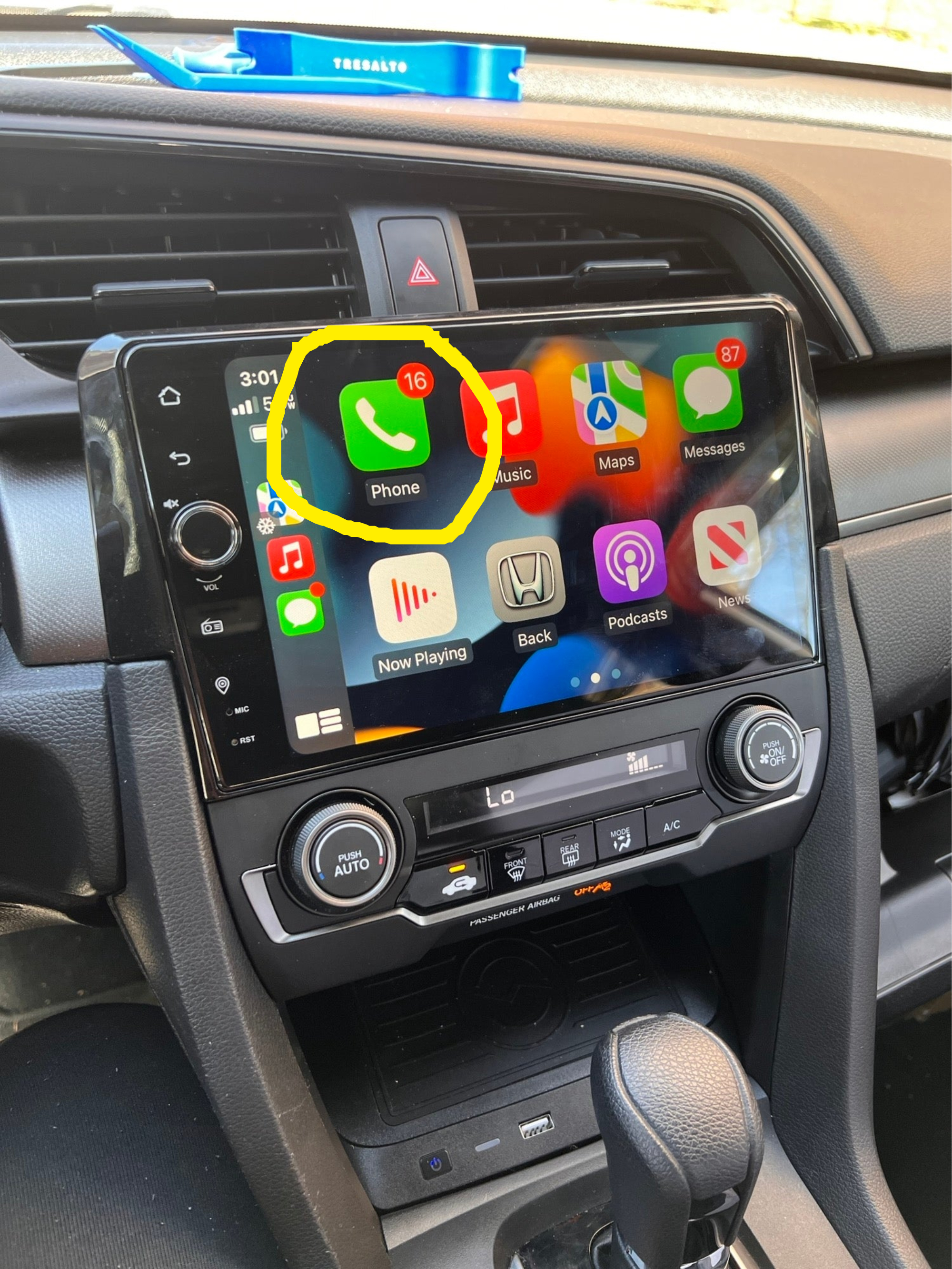 A car&#x27;s carplay screen with the phone app circled