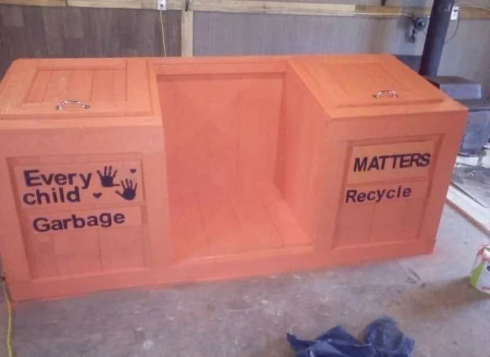 a combined garbage and recycling bin; the left side has the words &quot;every child garbage&quot; while the right reads &quot;matters recycle&quot;