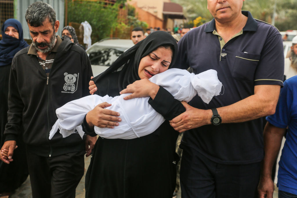 A woman holding her dead child