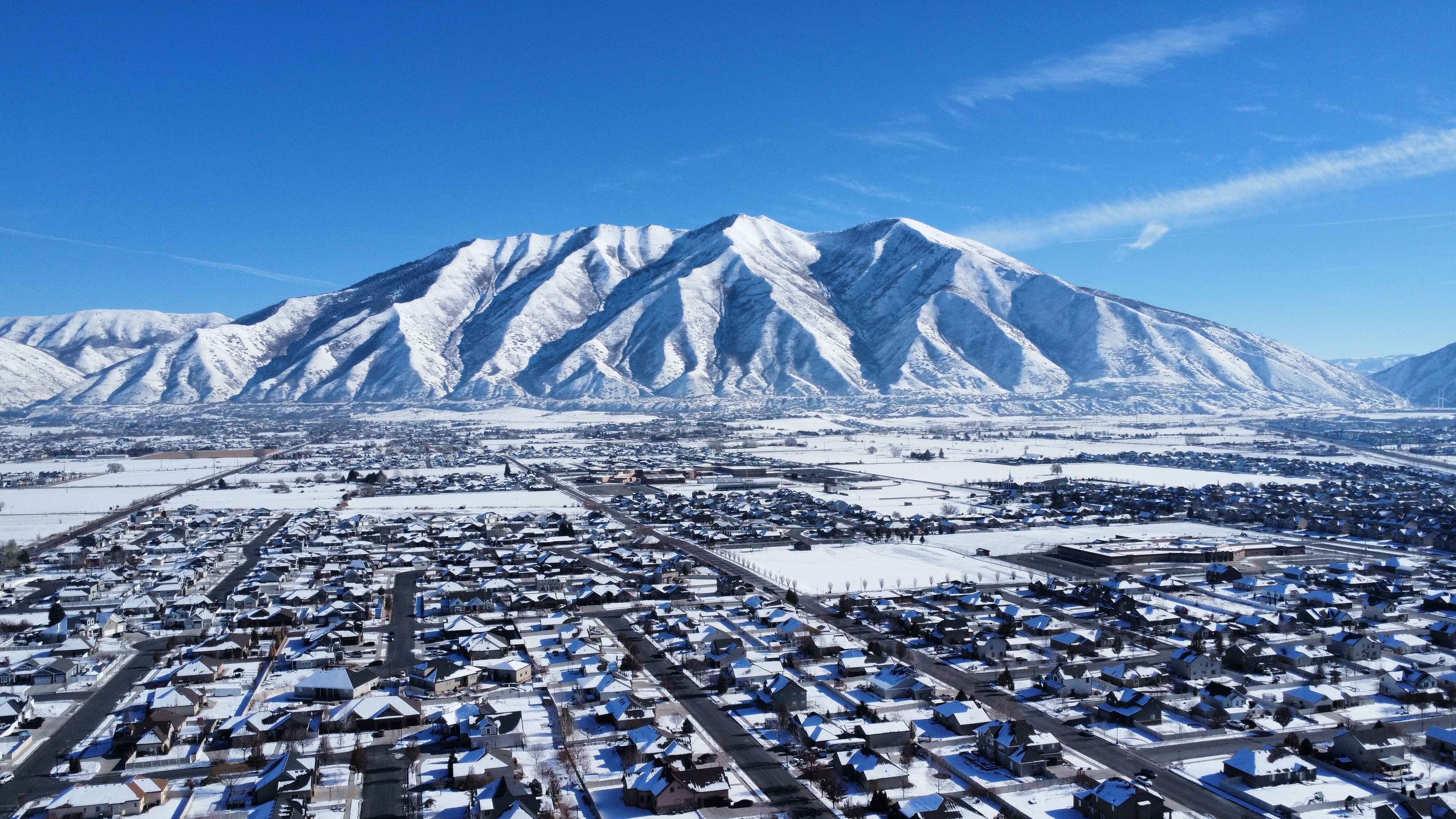 Aerial view of snowcapped mountains against blue sky in Spanish Fork, Utah