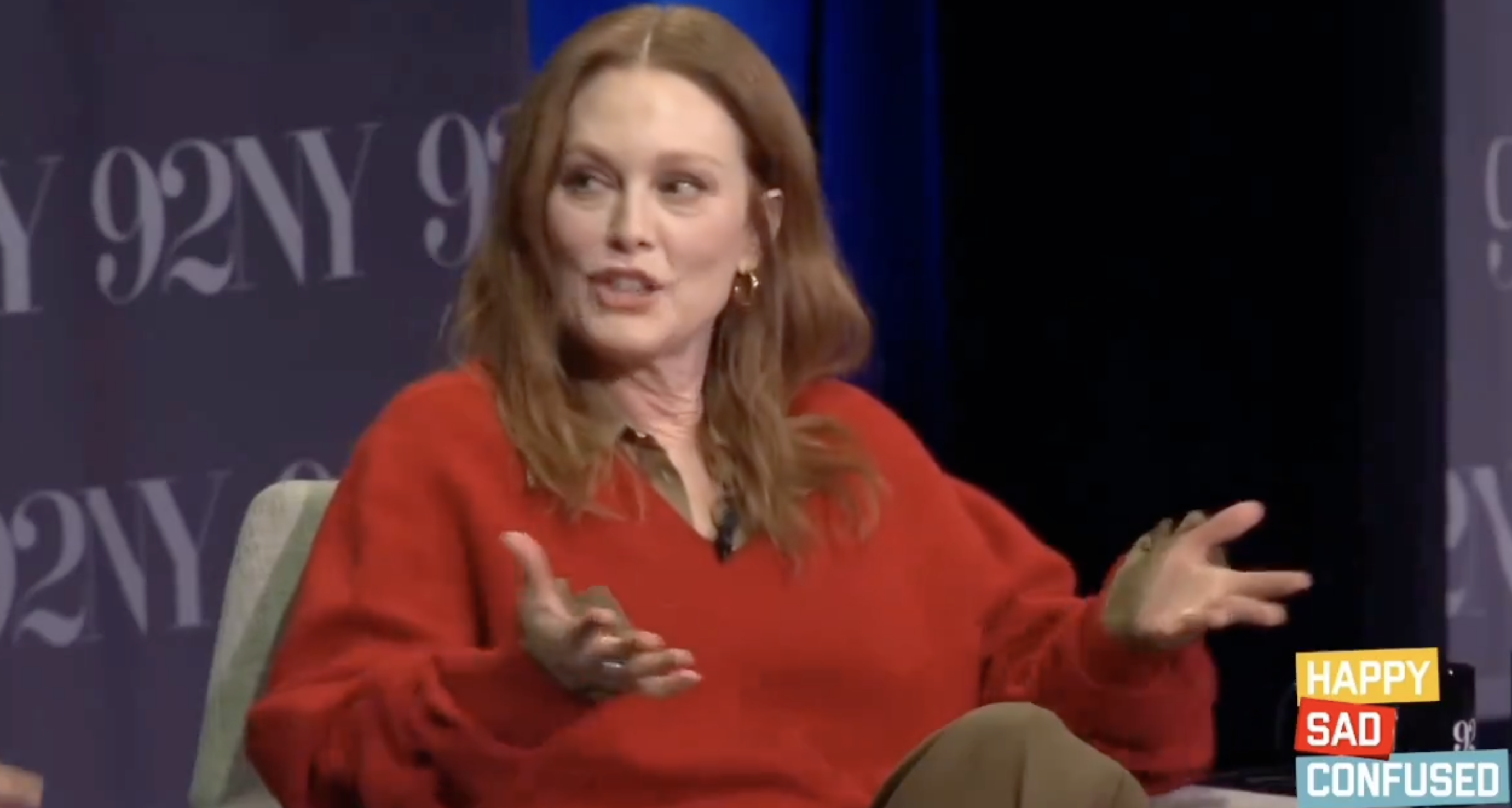 Close-up of Julianne seated and speaking onstage