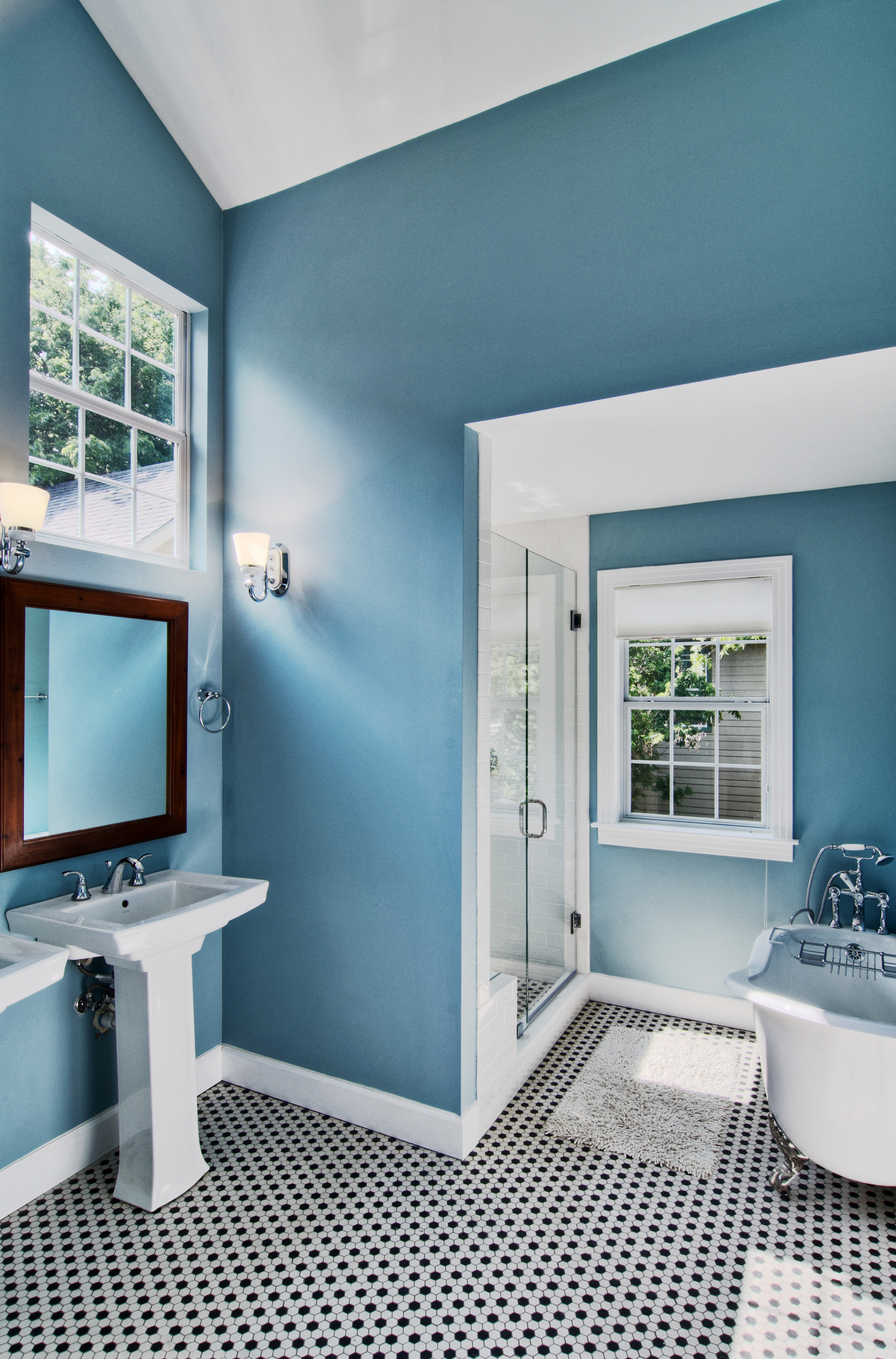 ocean blue bathroom walls in a large bathroom with tub and shower