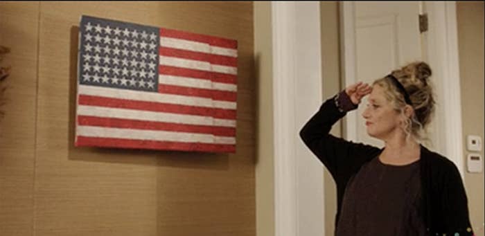 a woman saluting the american flag
