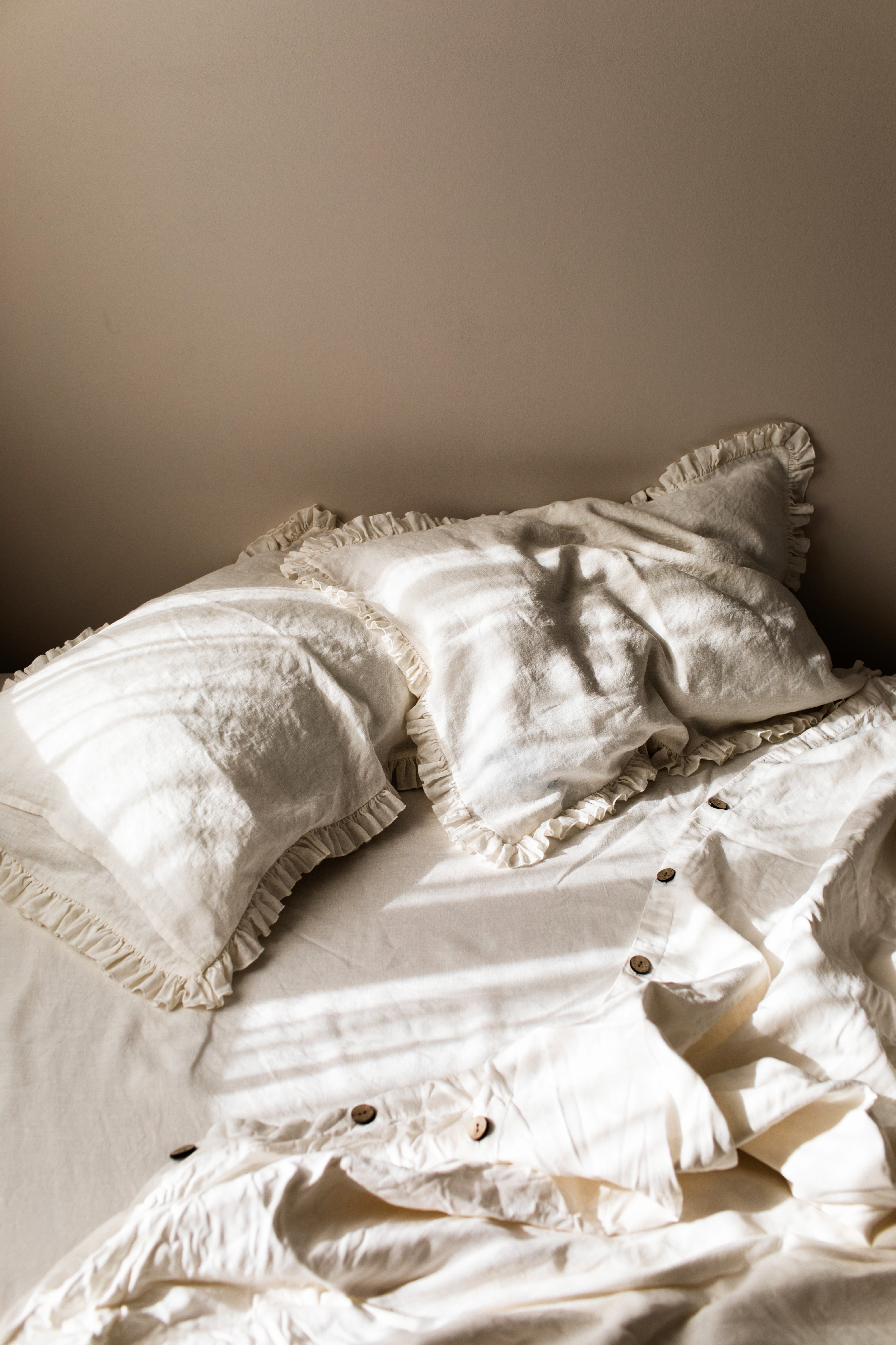 ruffled pillows on a bed