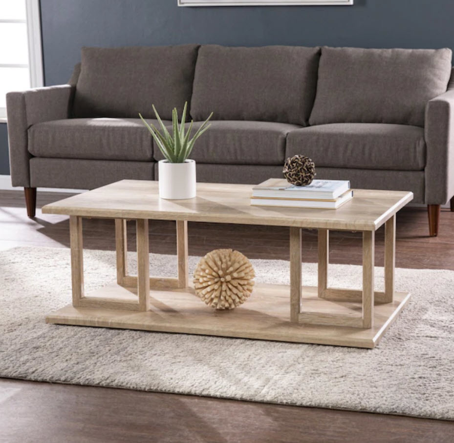 glossy wood coffee table with geometric features in base and open storage space
