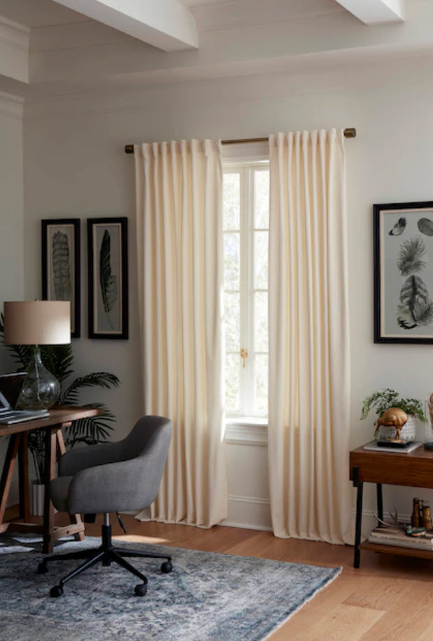 set of cream linen curtains in office room window