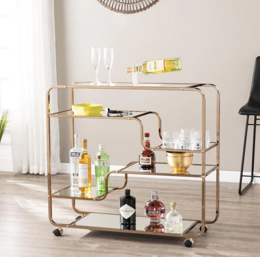 wavy shelved bar cart with alcohol bottles and glasses