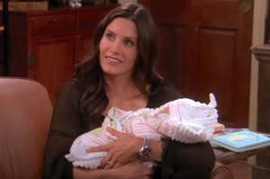 Monica from Friends holding a swaddled baby