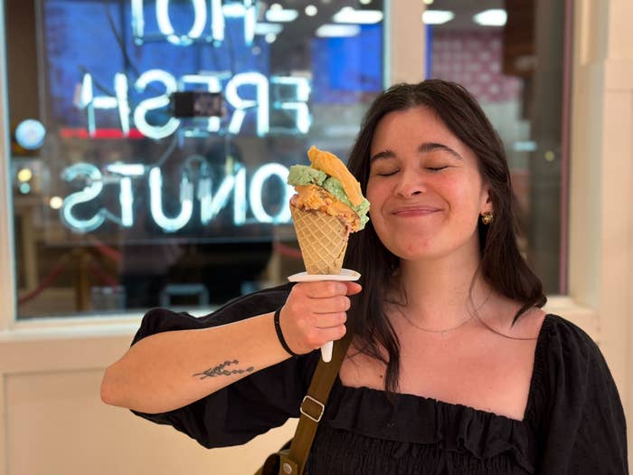 Anna (me!) holds an ice cream cone piled high with pistachio, sherbet, and chocolate ice cream; I&#x27;m smiling with no teeth showing, and my eyes are closed