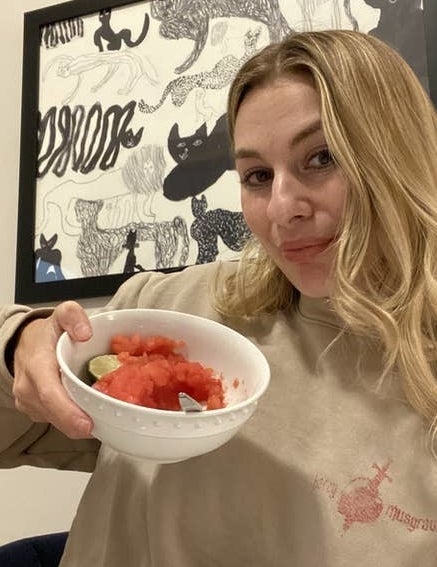 author holding up a bowl of watermelon sorbet
