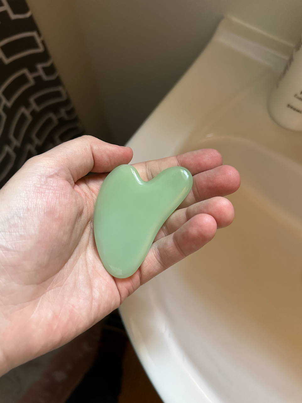 a gua sha in a hand