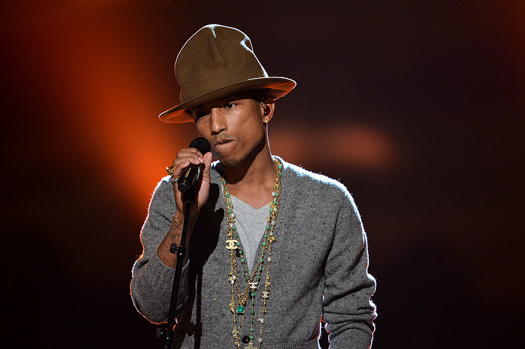 pharrell on stage wearing a tall hat
