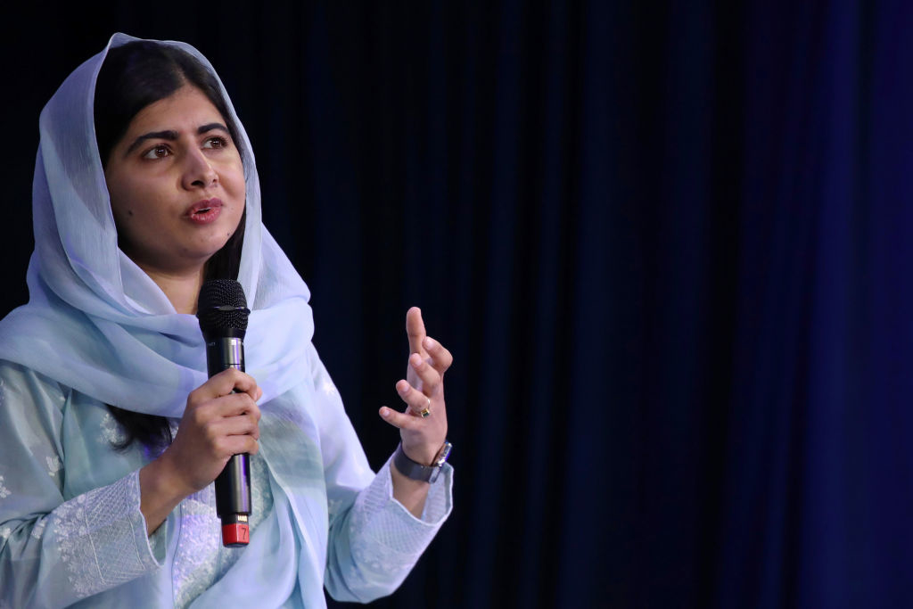 malala on stage with a mic