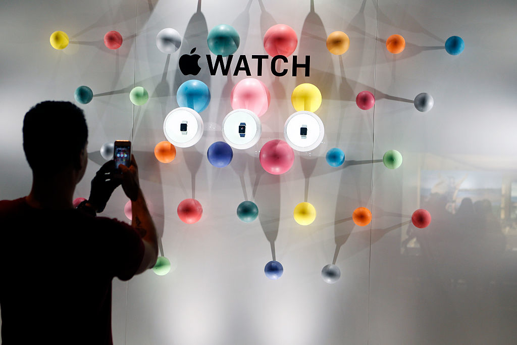 man taking picture of apple watch display