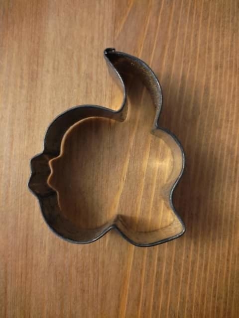 A cookie cutter that&#x27;s difficult to identify, but maybe showing a face on one side