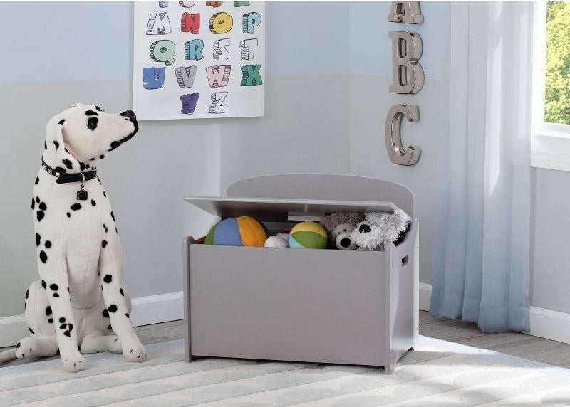 a gray toy box filled with toys