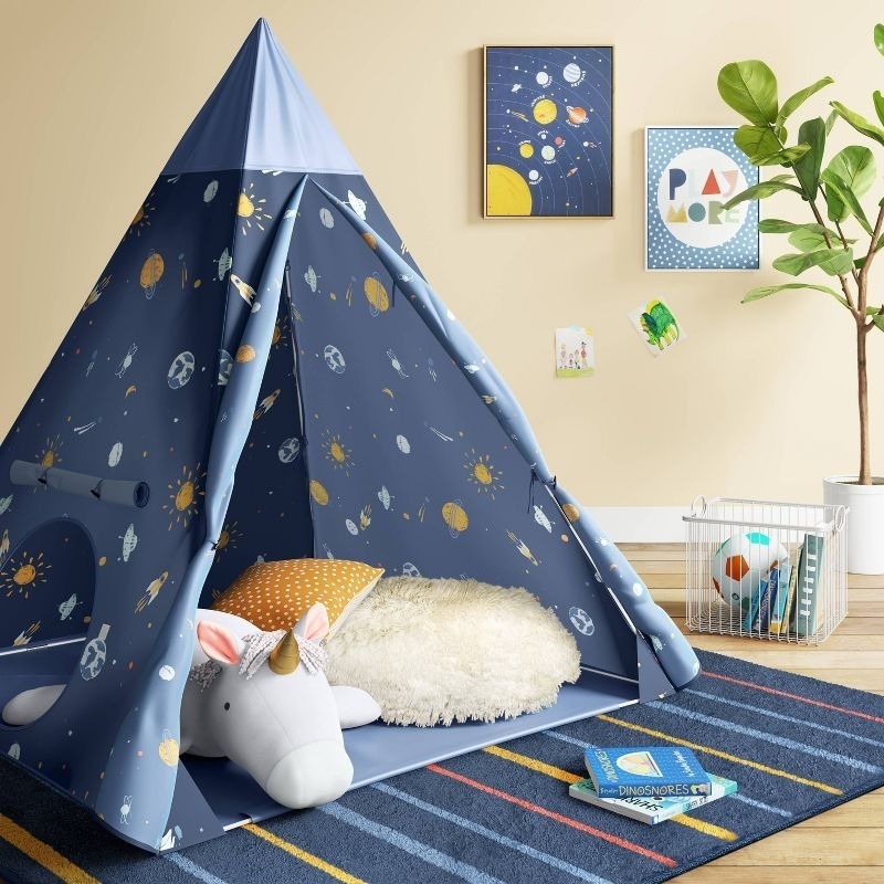 a space-themed play tent in a room