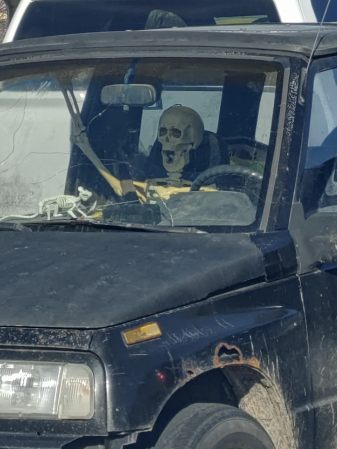 a fake skeleton in a car