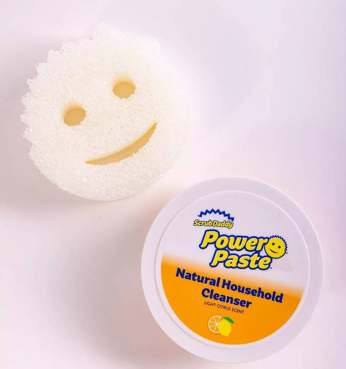 the ScrubDaddy brand smiley face-shaped sponge and the container of cleaning paste