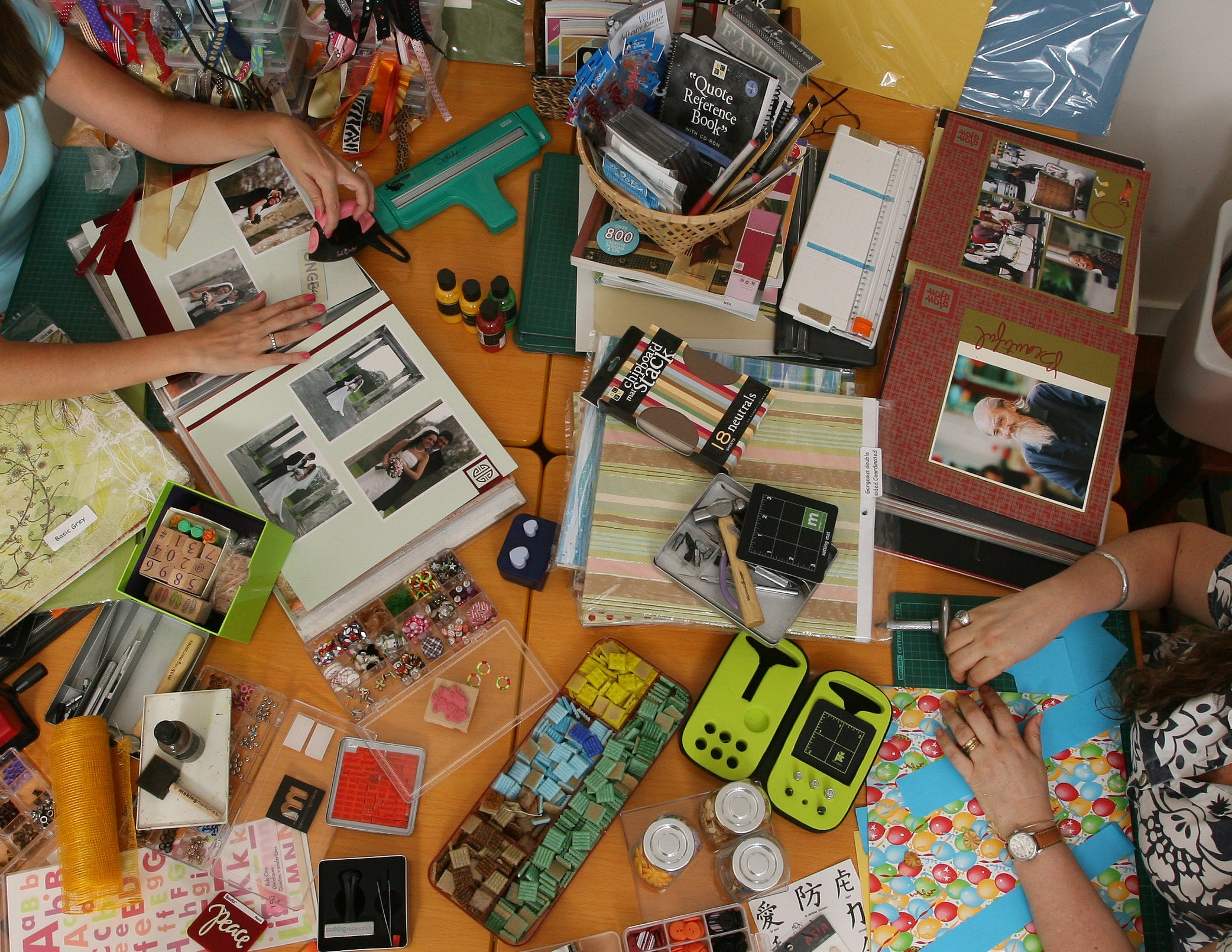people scrapbooking on a table