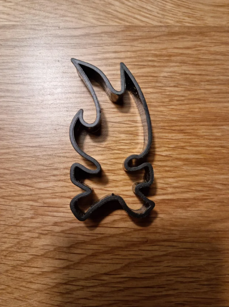 A cookie cutter that&#x27;s difficult to identify but could be a cartoon character running or on fire