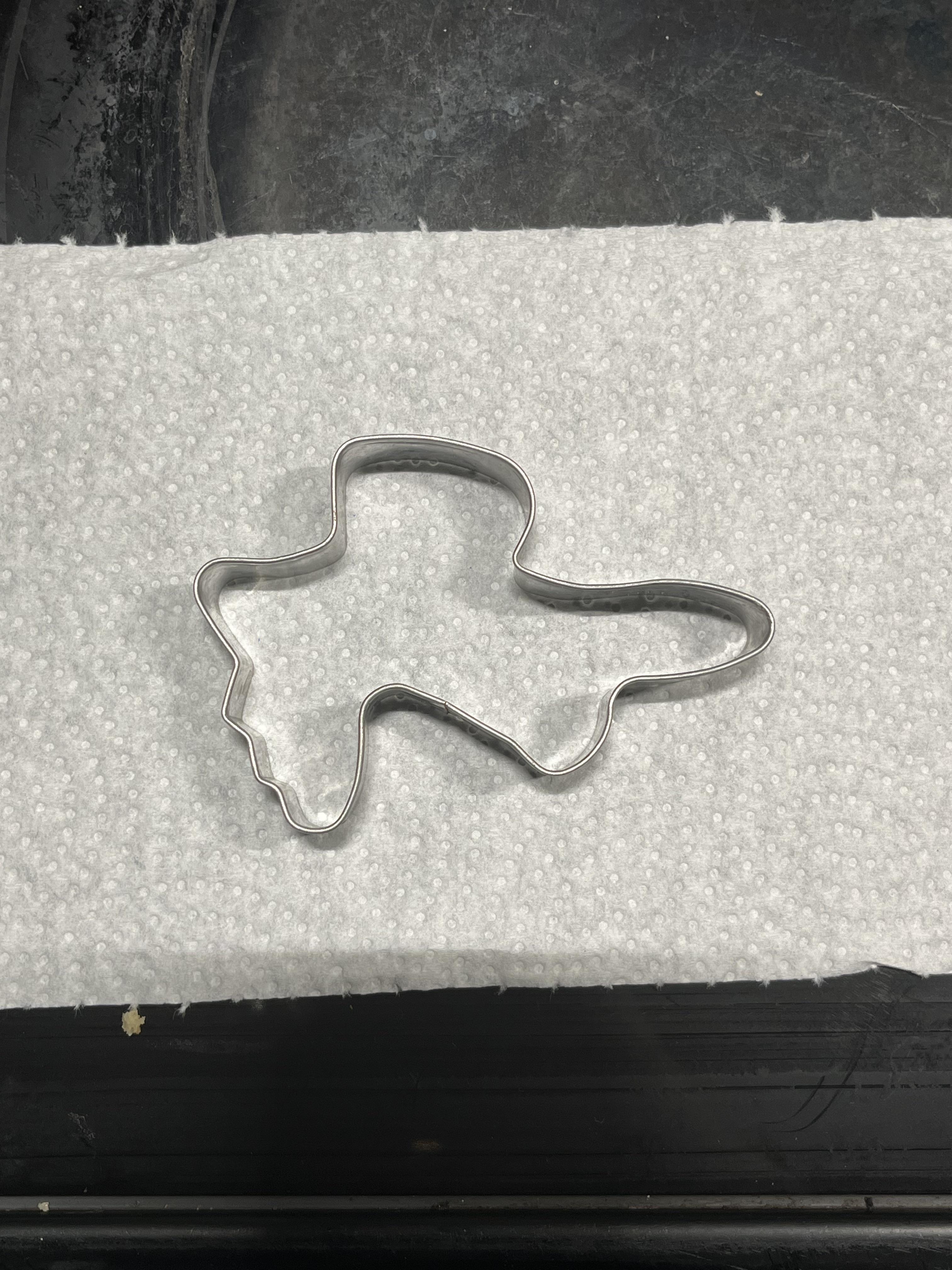 A cookie cutter that&#x27;s difficult to identify, with a lump in the middle and two misshapen lumps at the bottom