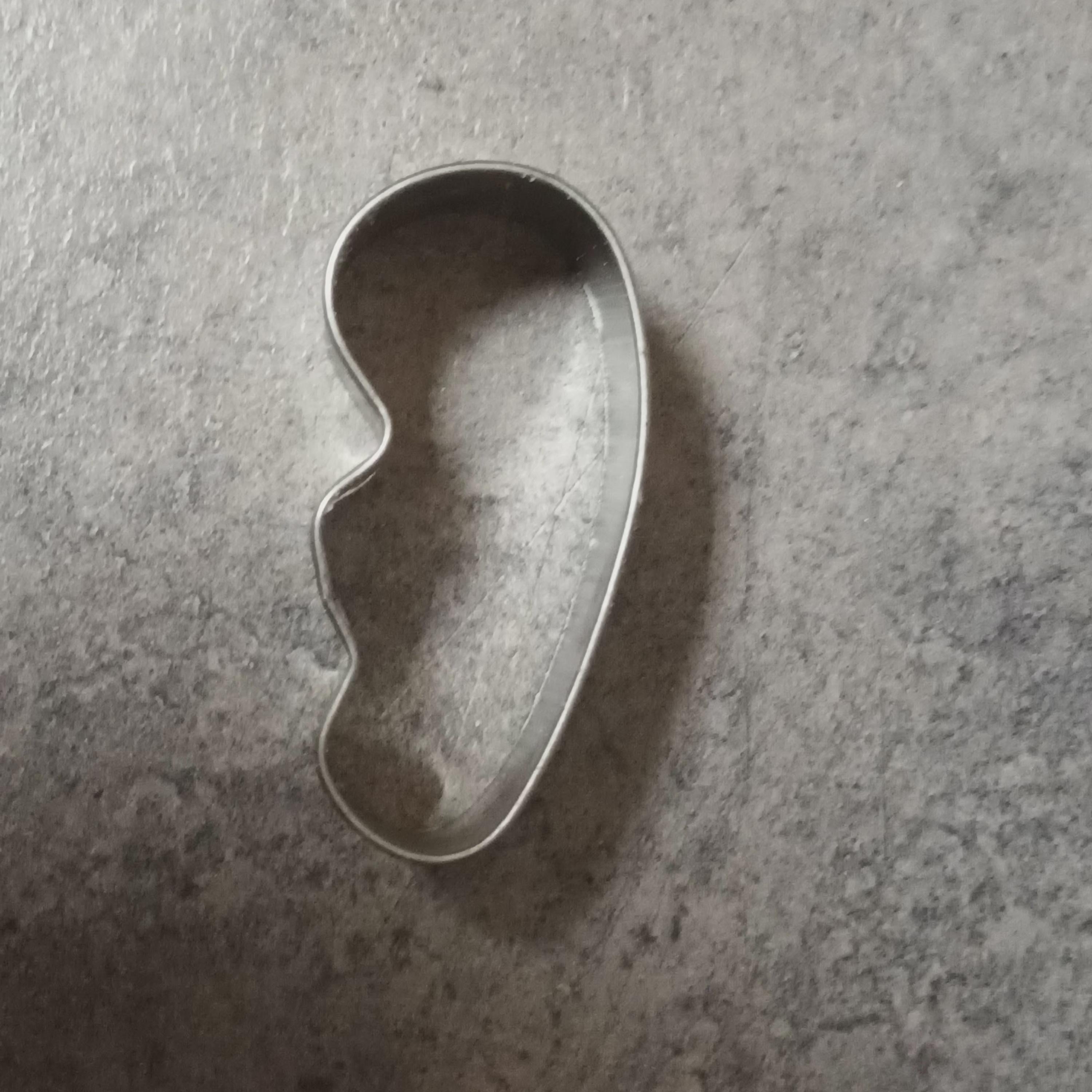 A cookie cutter that&#x27;s difficult to identify but could be an embryo or a lumpy peanut