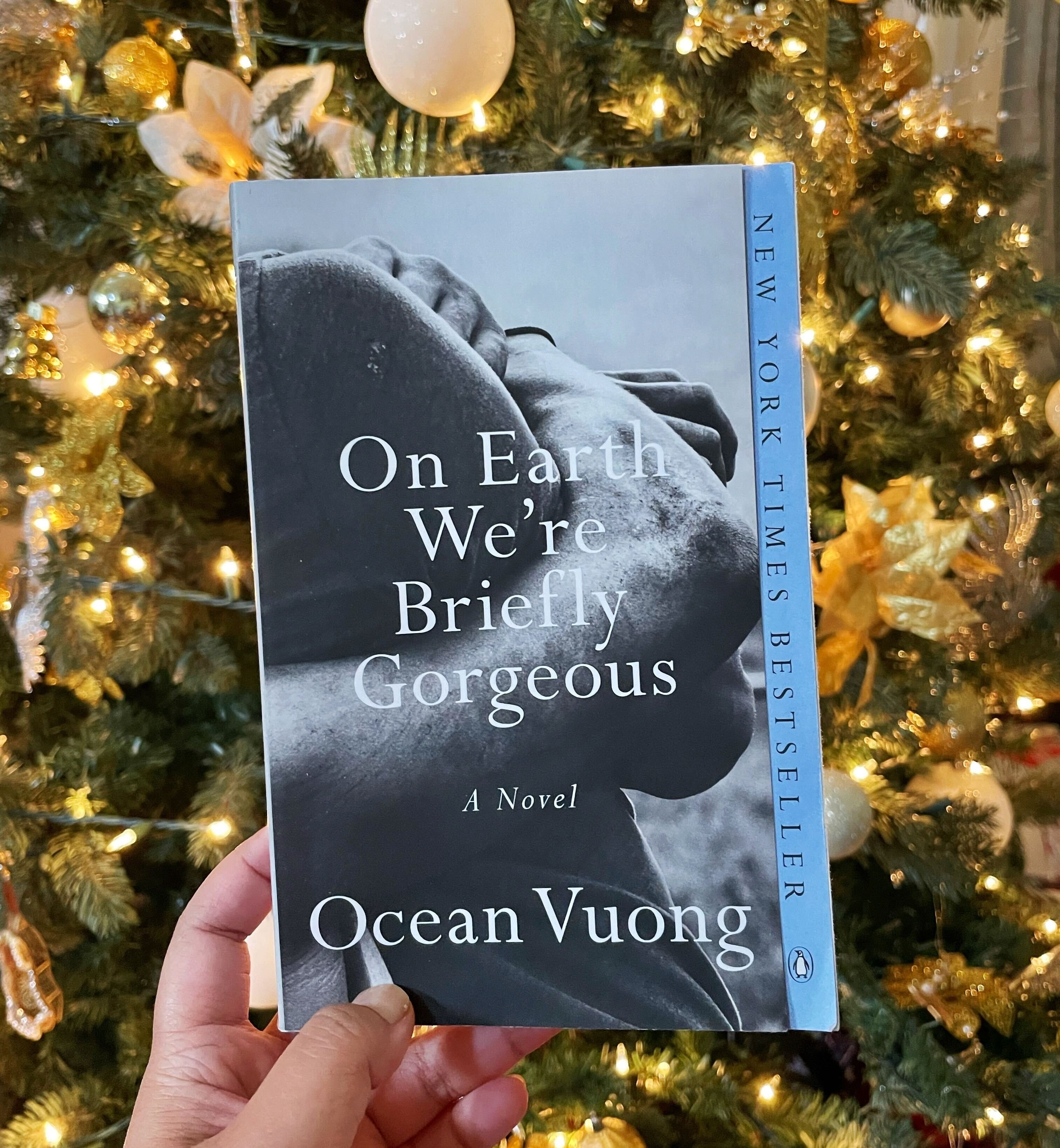 The author is holding her copy of Ocean Vuong&#x27;s &quot;On Earth We&#x27;re Briefly Gorgeous&quot;