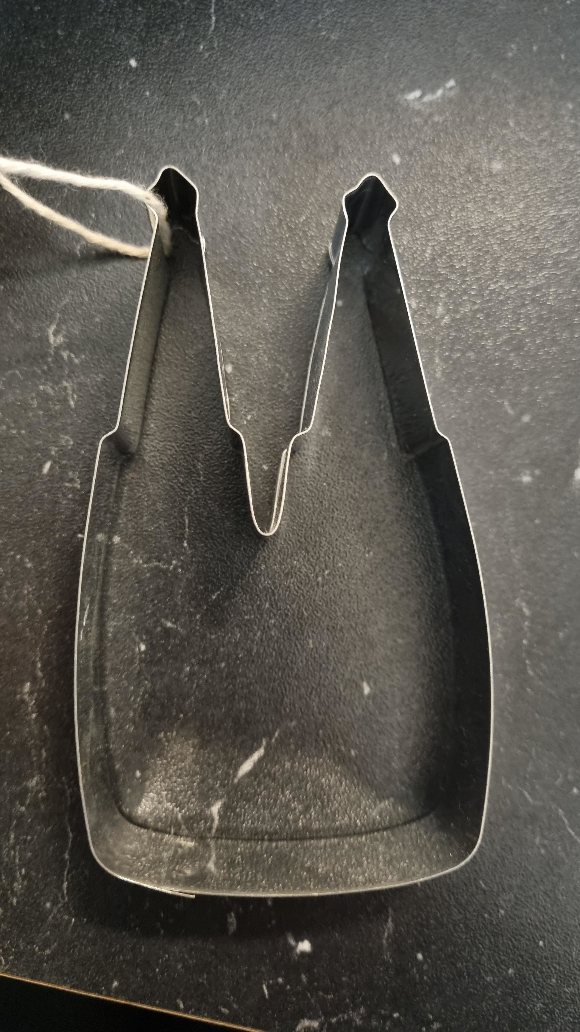 A cookie cutter that&#x27;s difficult to identify but could be two beer bottles next to each other
