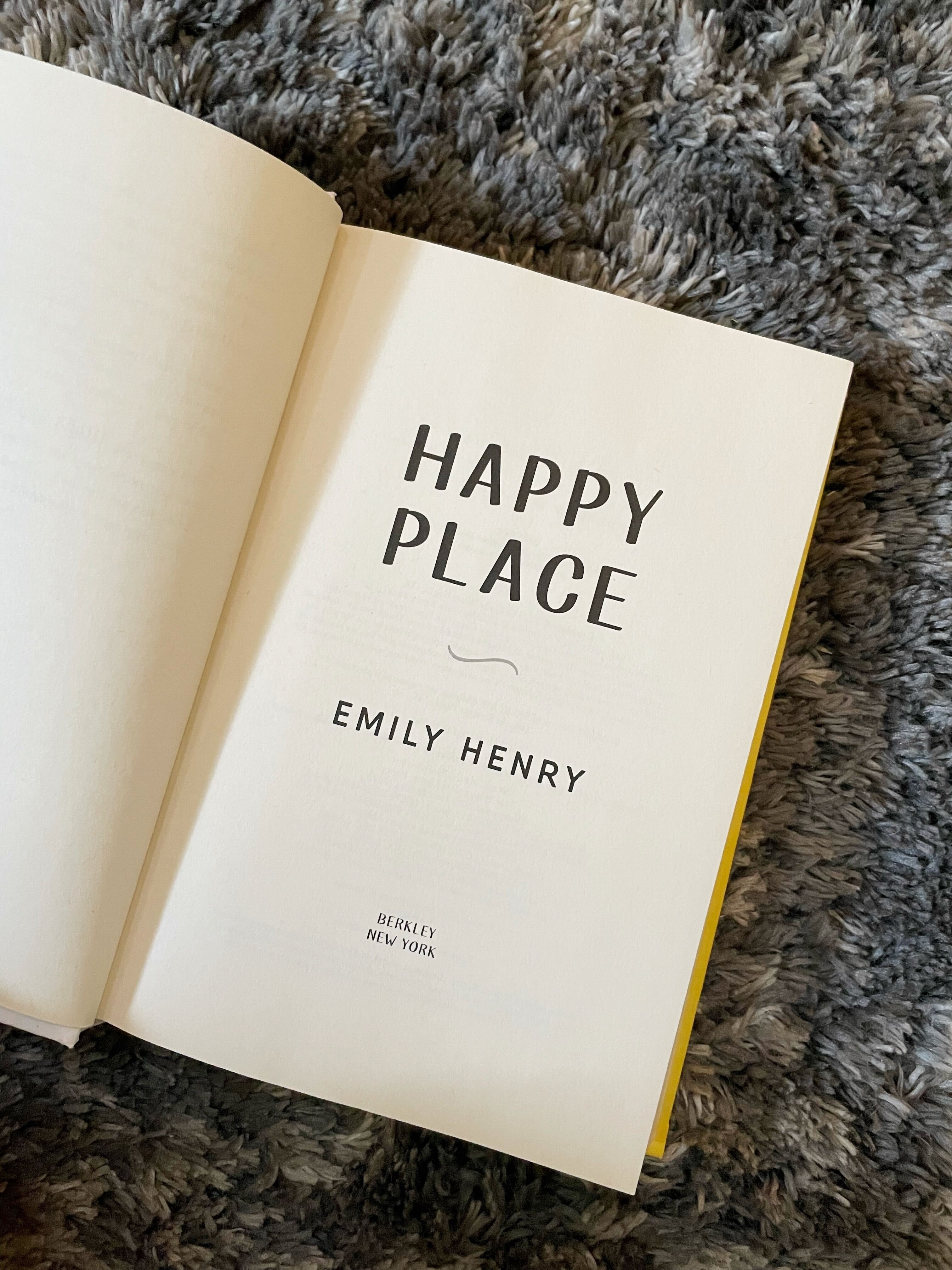 The author is showing off a copy of Emily Henry&#x27;s &quot;Happy Place&quot;