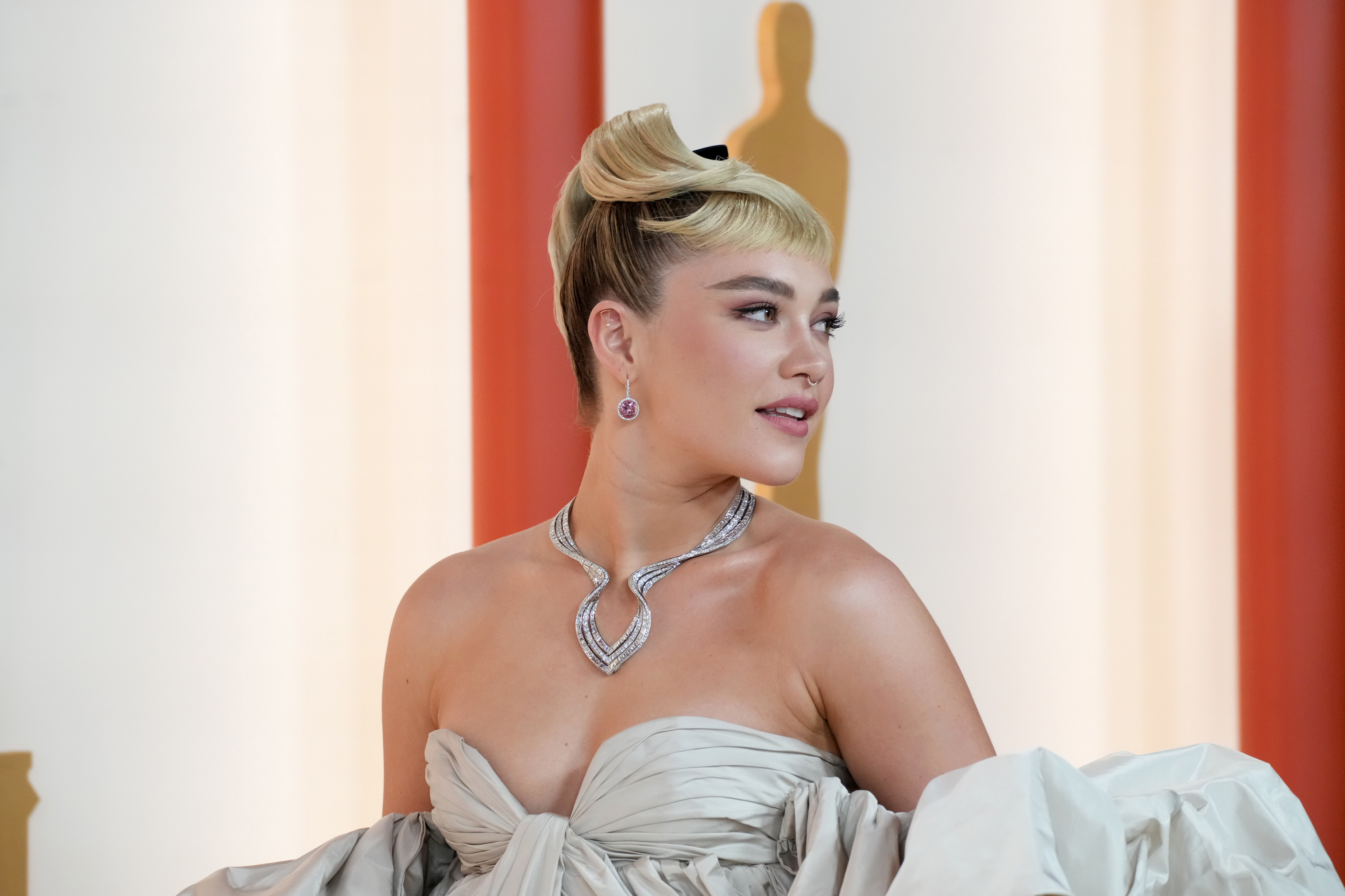 Close-up of Florence in a strapless outfit at a media event