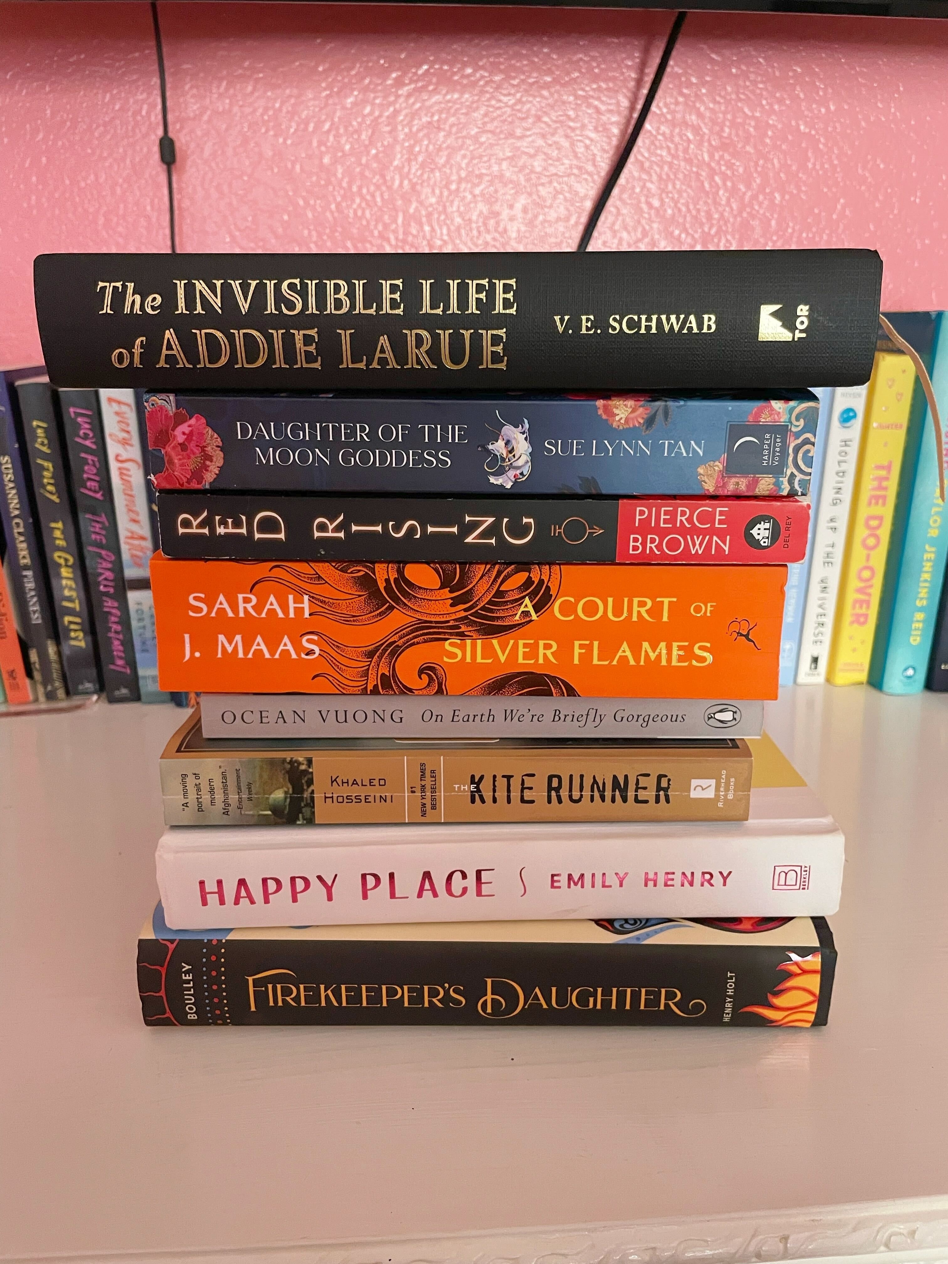 The author is showing some of her favorite books of the year stacked up
