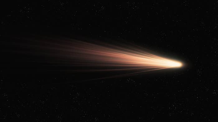 a comet running through a pitch black sky