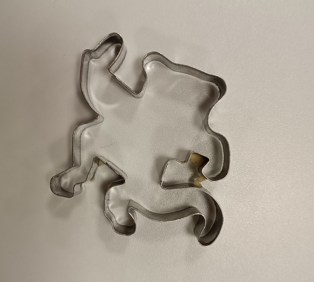 A cookie cutter that&#x27;s difficult to identify but could be a cartoon character with a tail running