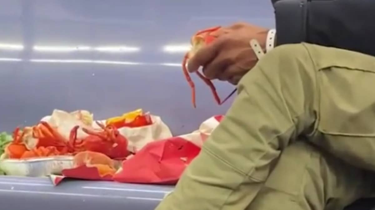 The man was taking up several seats on the train, clearly enjoying his meal.