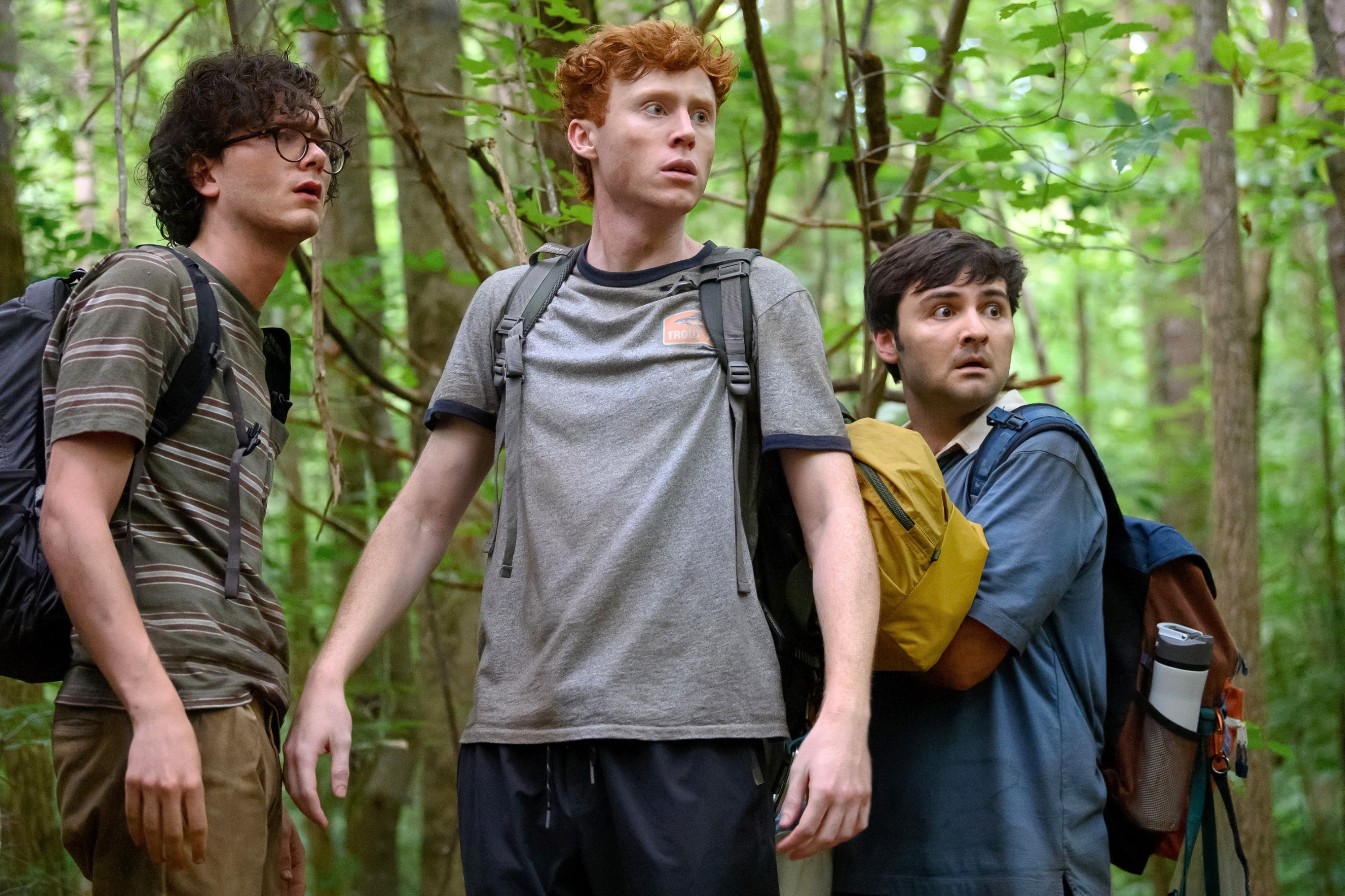 Martin, Ben, and John in the woods wearing backpacks